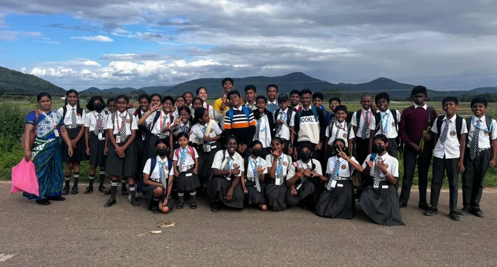 Students enjoying a school nature trip surrounded by Karnataka's scenic landscape
