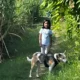 Young girl exploring a green nature trail with a friendly dog at ChukkiMane