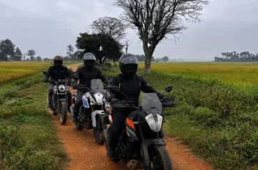 Bikers riding through Karnataka countryside near ChukkiMane