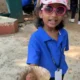 Child proudly holding a handmade seed ball at ChukkiMane