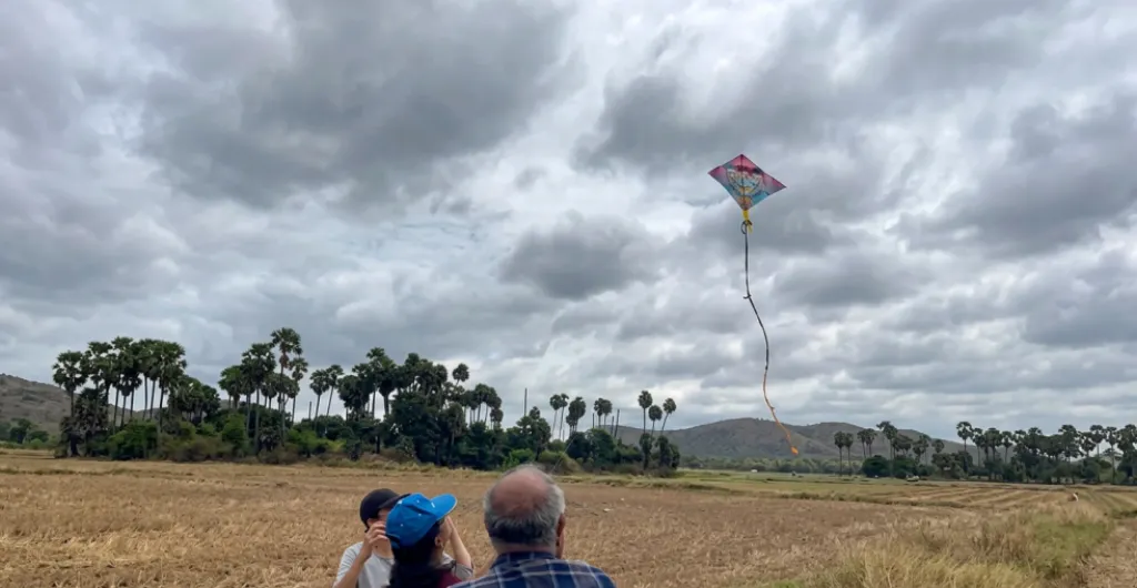 Family enjoying kite flying in the open fields at ChukkiMane Family enjoying kite flying in the open fields at ChukkiMane