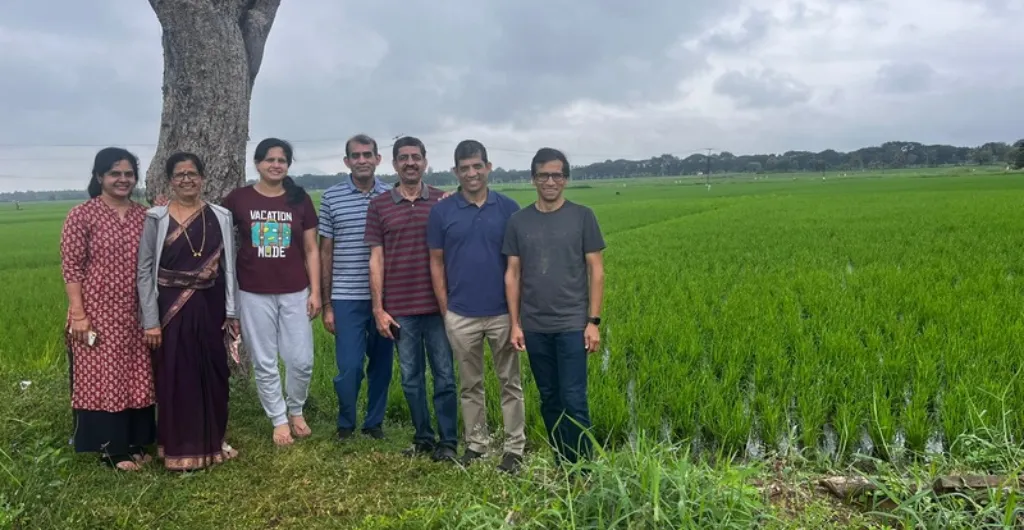 Visitors enjoying a peaceful outdoor experience surrounded by green fields