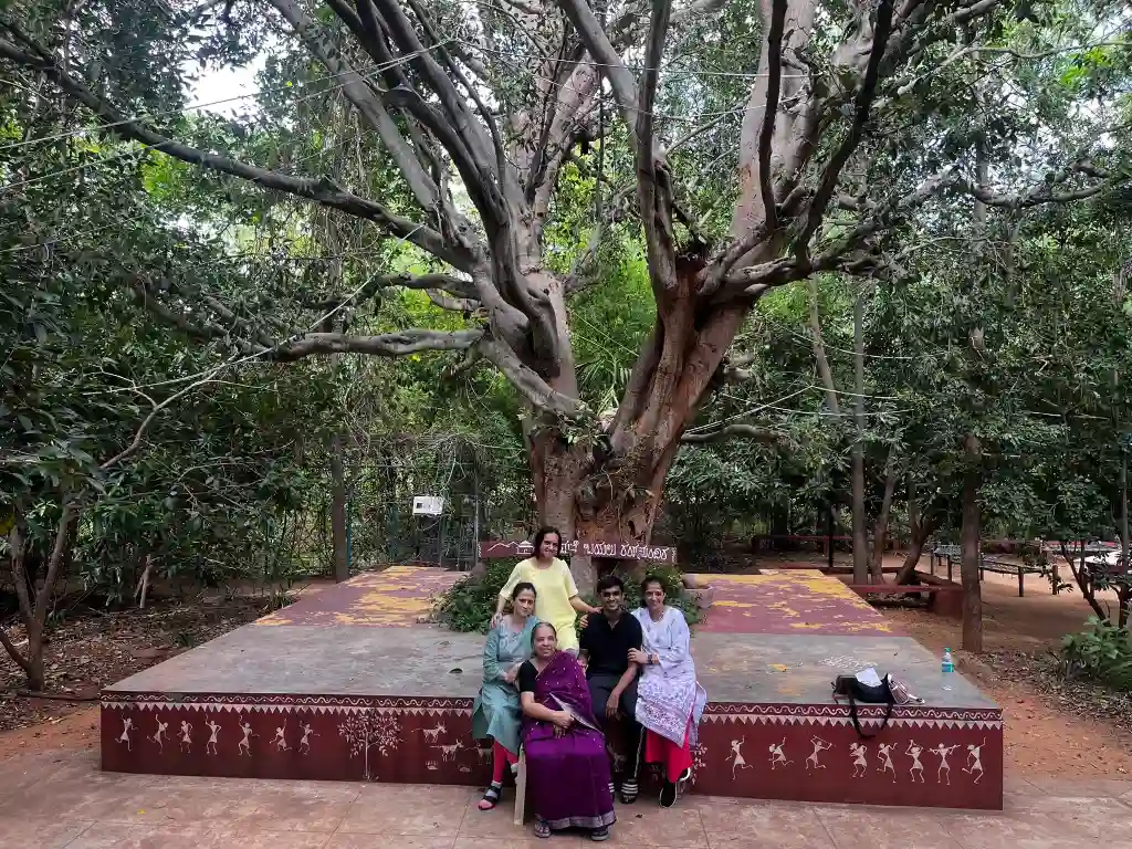 Family enjoying nature beneath a banyan tree